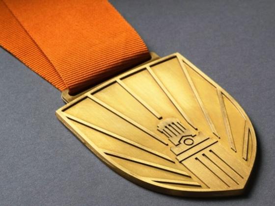 president's research impact award gold medal with burnt orange ribbon