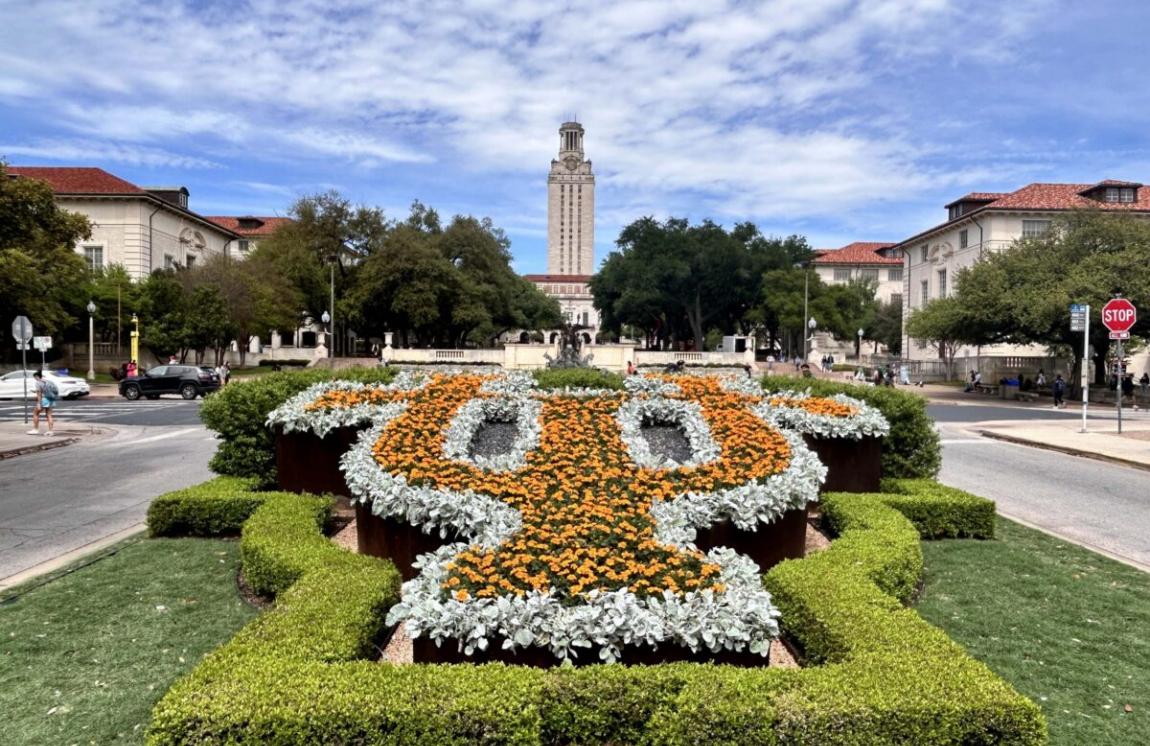 ut tower in background with interlocking UT in flowers in foreground