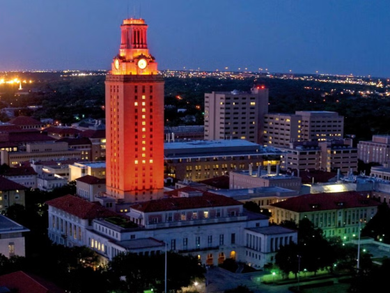 The University of Texas Tower lit up orange with the number 1 shining in the windows.