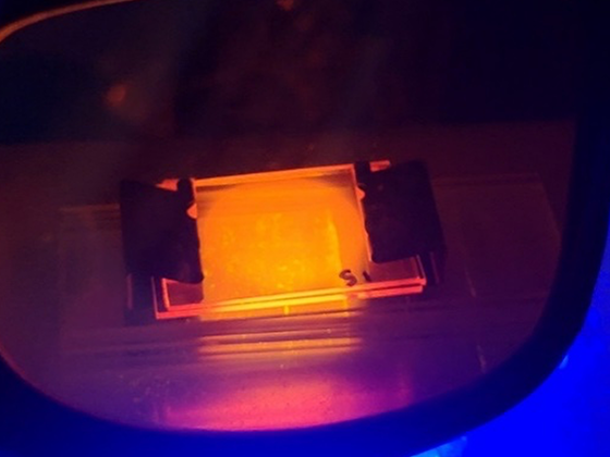 UV light is used to prepare resin-coated glass in the first step of the 3D printed semiconductor chip manufacturing process.