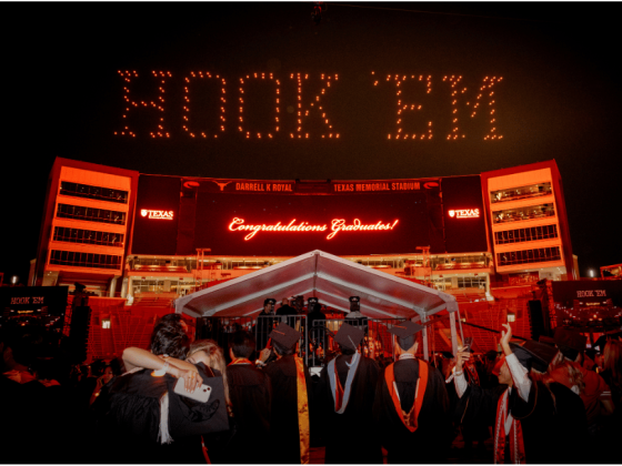 Drones spell out "HOOK EM" in the night sky above Darrell K Royal-Texas Memorial Stadium on the UT campus.