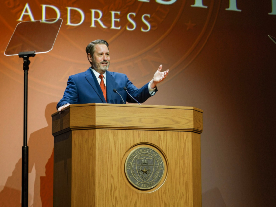 A man stands behind a podium while delivering a speech.
