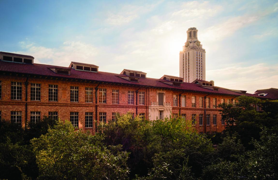 A photo of a building on the University of Texas Campus with the Tower in the background.