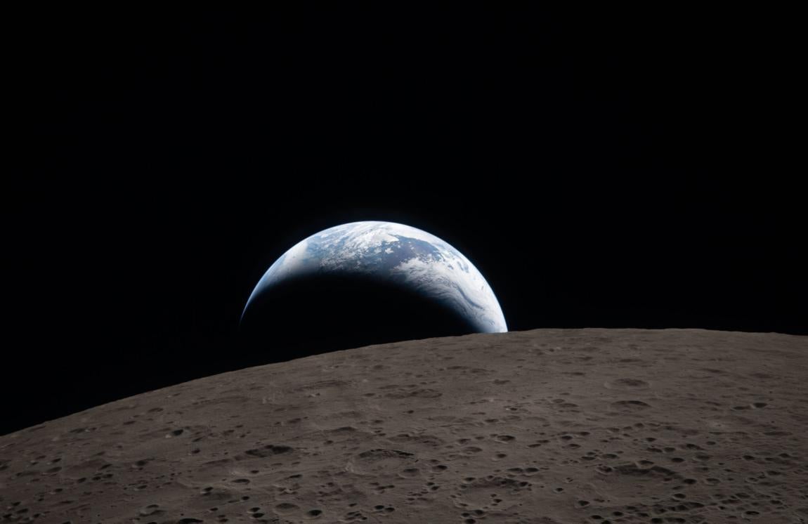 Earthset captured through the Orion spacecraft window on April 6, 2026, during the Artemis II crew’s flyby of the moon.