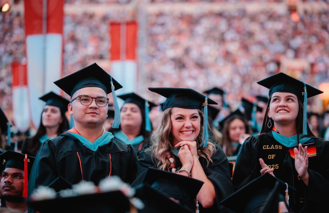 Three master's degree graduates at The University of Texas at Austin's 2025 University-Wide Commencement Ceremony