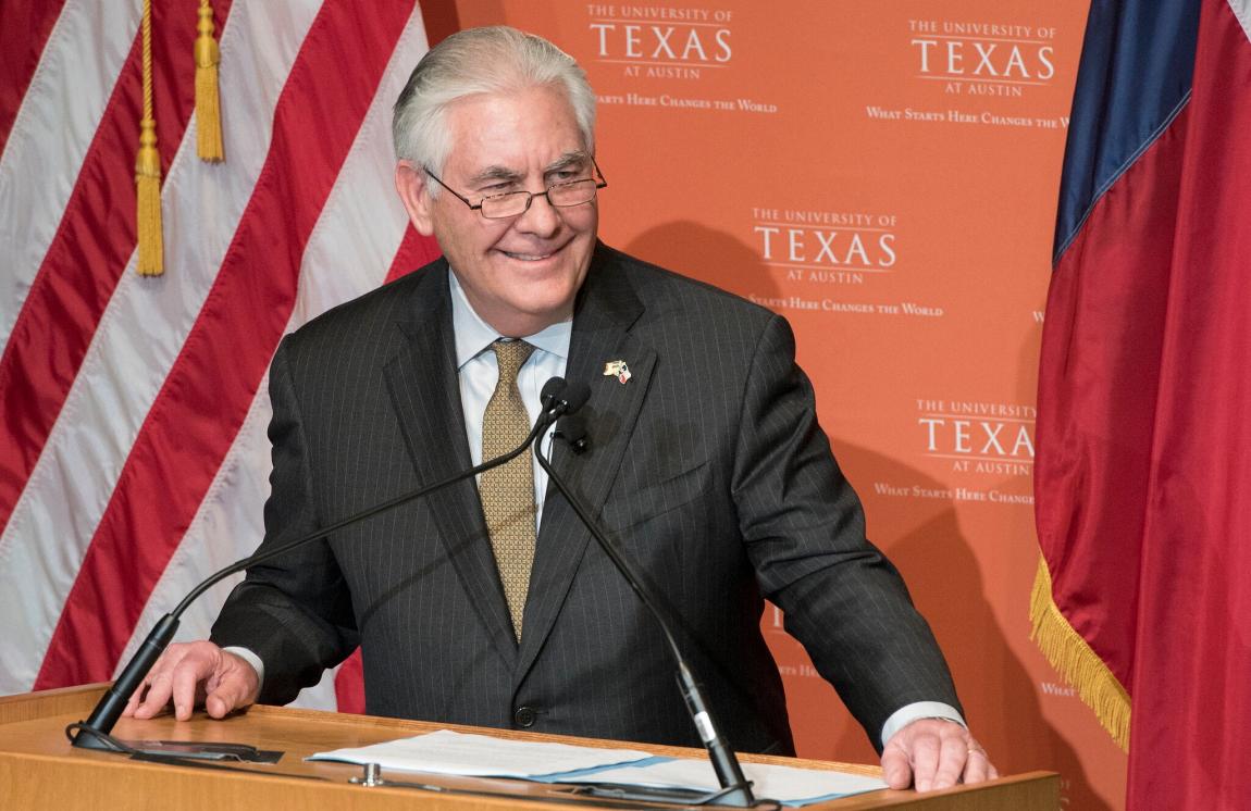 Rex Tillerson stands at podium