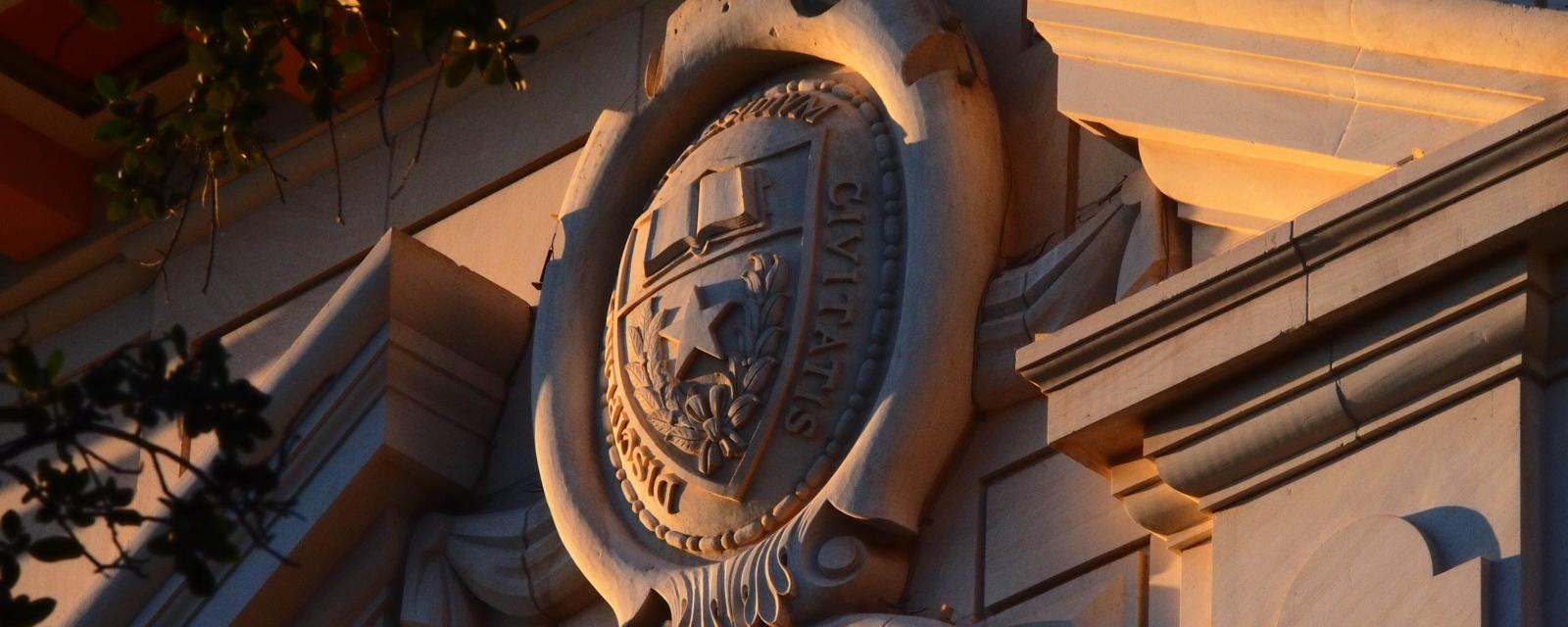 UT seal on Benedict Hall with shadows