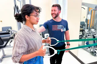 Physical therapist working with student