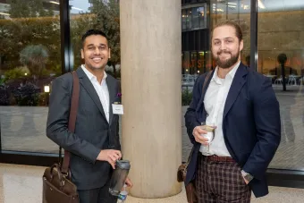 Two men pose for a photo at an event