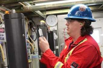 Worker inspecting energy equipment