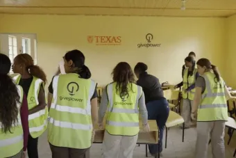 Students learning in classroom wearing safety vests