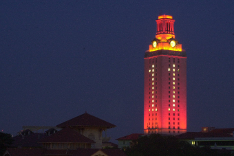 The University of Texas at Austin Tower lit up orange with "1" shining through the windows.
