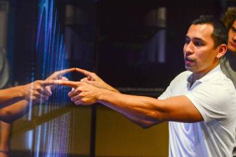A man giving a demonstration on a touch screen.