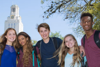 High school students pose for a photo in front of the UT Tower