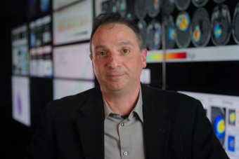 Man in front of imaging screens.