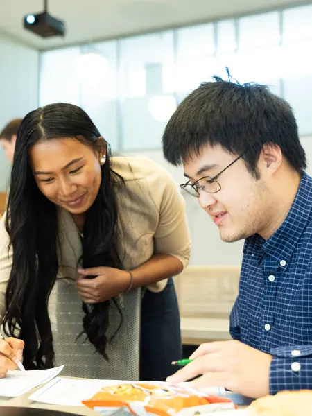 Two people reviewing a document