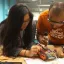 two people work on an electronic device
