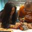 two people work on an electronic device