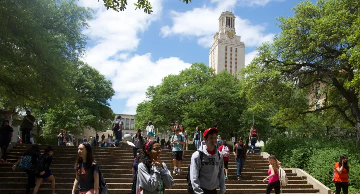 Students walking on campus with UT tower in background