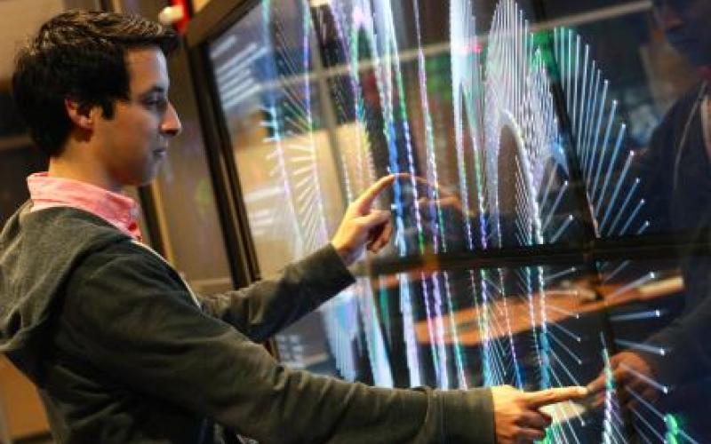 Man interacts with a screen that follows his finger placement.