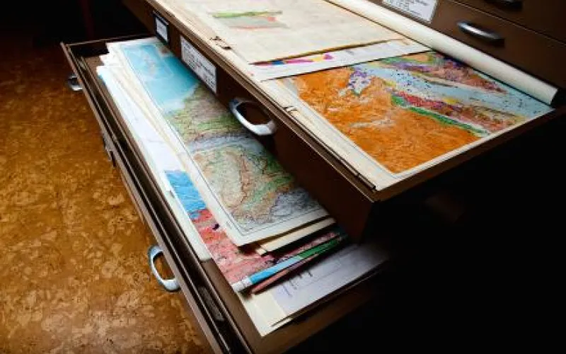 Geology books partially open on desk