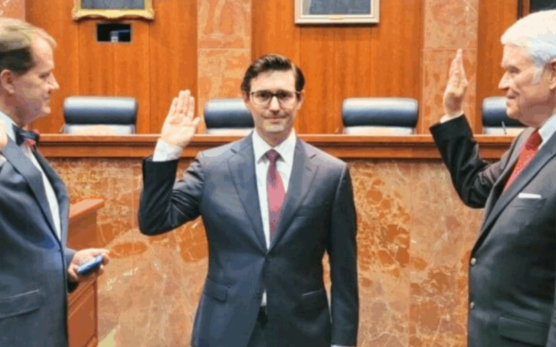 Three men raising their right hand in a courtroom.