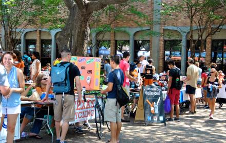 Students browsing student organization tables at Party on the Plaza